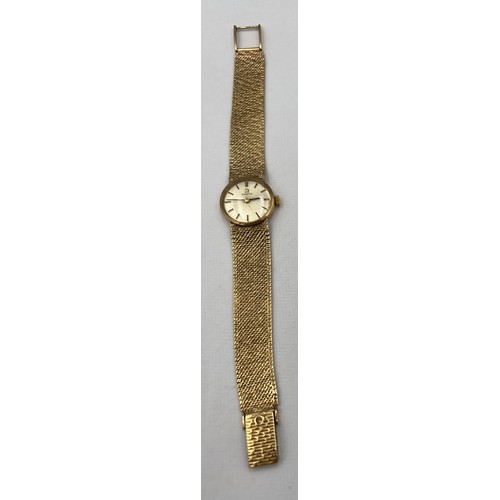 538 - A ladies 9 carat gold Omega wristwatch with 9 carat gold strap and Omega clasp. Total weight 26.4gm.