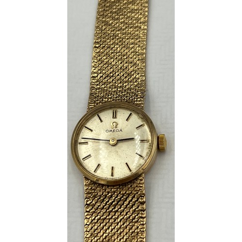 538 - A ladies 9 carat gold Omega wristwatch with 9 carat gold strap and Omega clasp. Total weight 26.4gm.