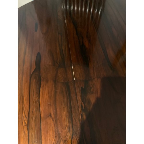 2 - A good quality rosewood centre table 133cm d x 75cm h.