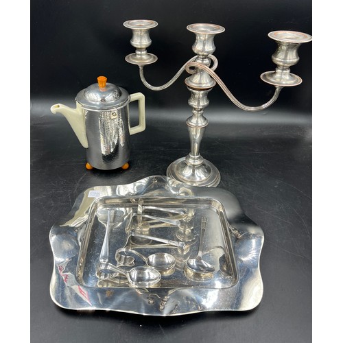 642 - Silver plated items to include tray, baby pushers and spoons, coffee pot and a candleabra.