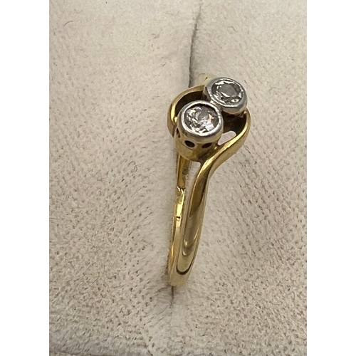 336 - An unmarked yellow metal ring set with two diamonds. Size K. Weight 1.9gm.