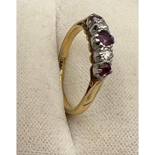 337 - An 18 carat and platinum ring set with diamonds and rubies. Size J/K. Weight 2.3gm.