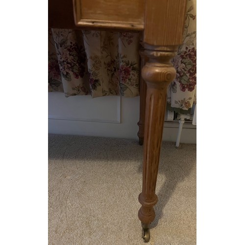 4 - A 19thC pine dressing table with reeded legs and brass castors. 105cm w x 55cm d x 74cm h.