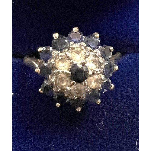 482 - A 9 carat gold cluster ring set with blue and clear stones. Size O. Weight 4gm.