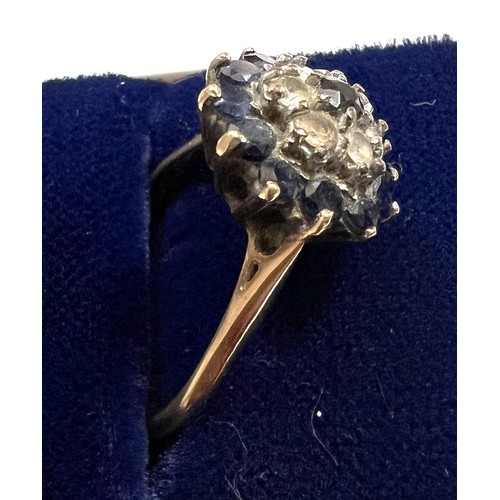 482 - A 9 carat gold cluster ring set with blue and clear stones. Size O. Weight 4gm.