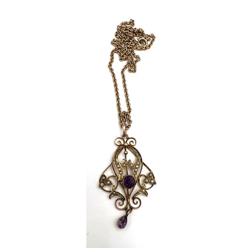 386 - An Edwardian 9 carat gold pendant set with amethyst and seed pearls suspended on an unmarked yellow ... 