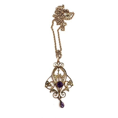 386 - An Edwardian 9 carat gold pendant set with amethyst and seed pearls suspended on an unmarked yellow ... 