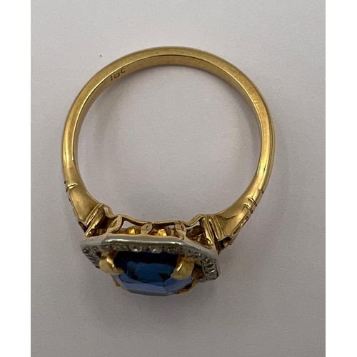 449 - A sapphire and diamond ring mounted in 18 carat gold and platinum. Size N/O. Weight 4.3gm. The cushi... 