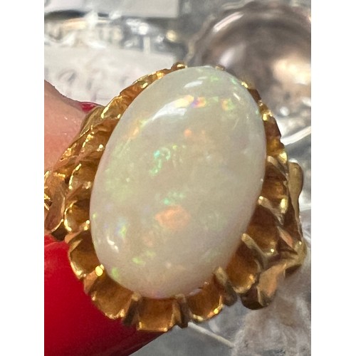 470 - An oval opal in claw setting in yellow metal, tests as 22 carat  gold. Size J, weight 5.5gm.
Opal 15... 