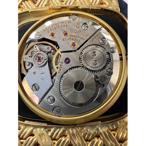 535 - An 18 carat gold Corum  bracelet watch with brown and cream feather dial, the winder set with a cabo... 