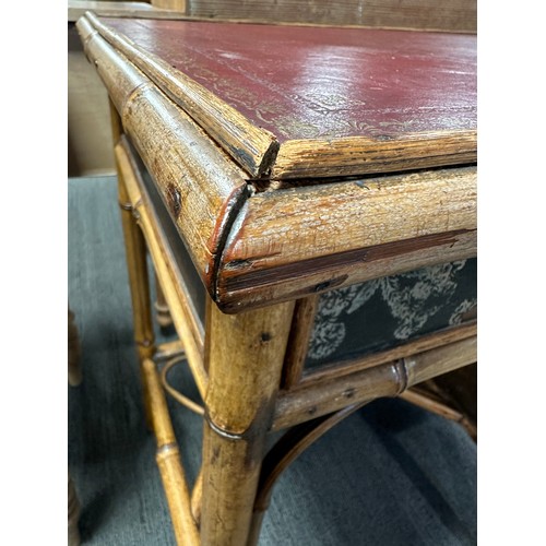 99 - A 19thC bamboo and lacquer kneehole desk with brass drop handles. 90cm w x 51cm d x 76cm h.