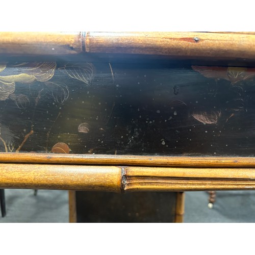 99 - A 19thC bamboo and lacquer kneehole desk with brass drop handles. 90cm w x 51cm d x 76cm h.