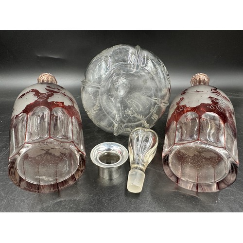 278 - Three etched decanters to include a clear decanter with stopper, cut and etched with thistles with a... 