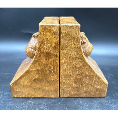 78 - Robert 'Mouseman' Thompson - a pair of oak adzed book ends. 15cm h.