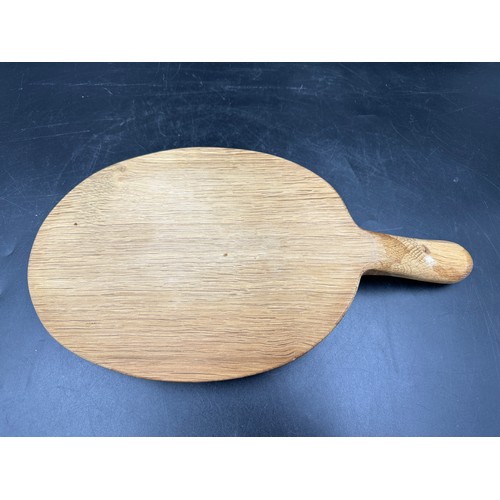 79 - Robert Thompson 'Mouseman' of Kilburn, an adzed oak cheese board of oval form with a carved mouse si... 