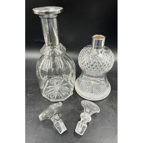 276 - Two silver necked glass decanters to include Sheffield 1901, maker Walker and Hall and Sheffield 192... 