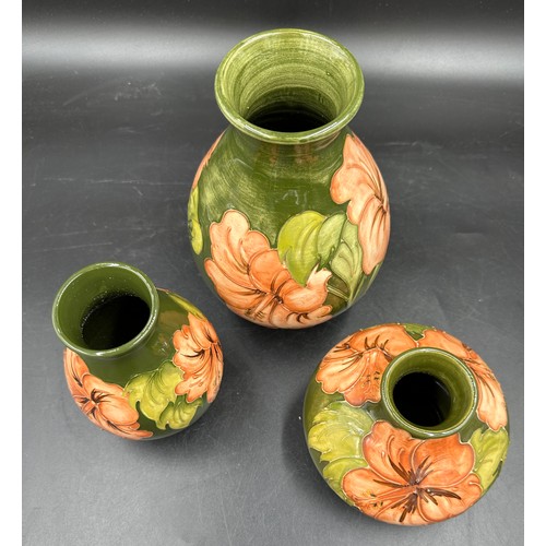 251 - A collection of Moorcroft Hibiscus pattern vases, largest 20cm h, two with signatures and Moorcroft ... 