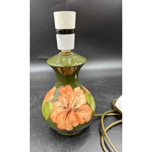 253 - Moorcroft Hibiscus on green ground table lamp, height to top of fitting approx 24cm along with a pla... 