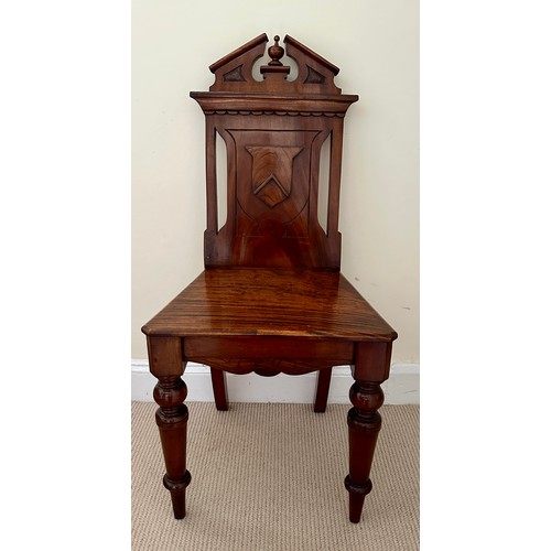 47 - A mahogany hall chair with shield back, solid seat and  turned legs. Ht 89 cm, to seat 44cm.