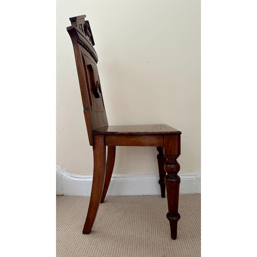 47 - A mahogany hall chair with shield back, solid seat and  turned legs. Ht 89 cm, to seat 44cm.