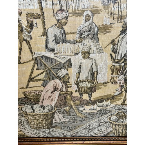 719 - A large early 19thC machine made tapestry-style picture of a Middle Eastern market/street scene in a... 