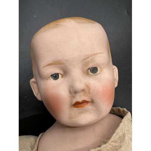 1121 - A Diamond Pottery Company bisque headed boy doll marked D.P.C 39-12 approx. 60cm together with a Ind... 