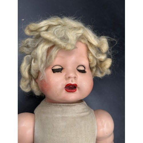 1121 - A Diamond Pottery Company bisque headed boy doll marked D.P.C 39-12 approx. 60cm together with a Ind... 