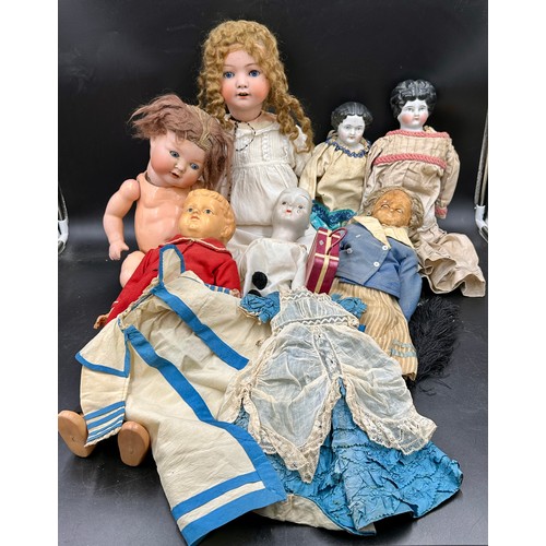 1129 - A Victorian doll's dress and cape together with a collection of mainly 19thC dolls to include a Heub... 