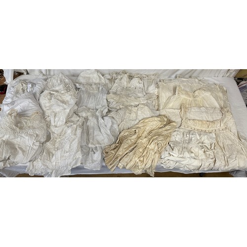 720 - Late 19thC/early 20thC linens to include 14 christening gowns, a camisole, nightdress and silk cream... 