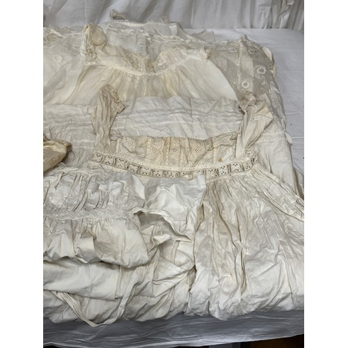 720 - Late 19thC/early 20thC linens to include 14 christening gowns, a camisole, nightdress and silk cream... 