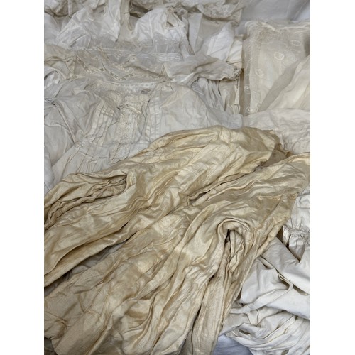 720 - Late 19thC/early 20thC linens to include 14 christening gowns, a camisole, nightdress and silk cream... 