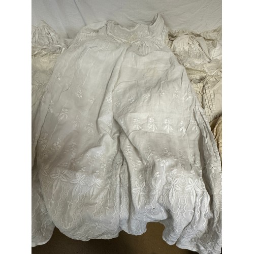 720 - Late 19thC/early 20thC linens to include 14 christening gowns, a camisole, nightdress and silk cream... 