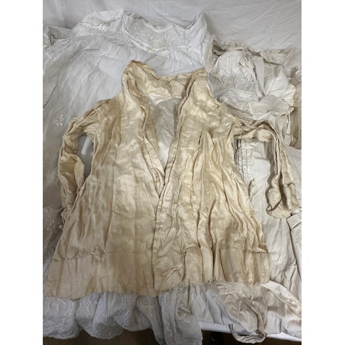 720 - Late 19thC/early 20thC linens to include 14 christening gowns, a camisole, nightdress and silk cream... 