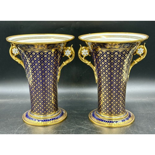 238 - Two twin handled vases with gilt decoration on a blue ground. Marks to base - Sevres 1838, one with ... 