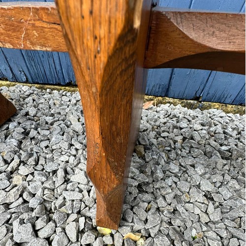 46 - A pair of oak trestle type benches/stools with rectangular tops on shaped ends joined by stretchers,... 