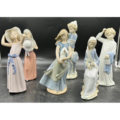 234 - Three Nao by Lladro figurines to include girl with a goat approx. 30cm h, girl with a rabbit approx.... 