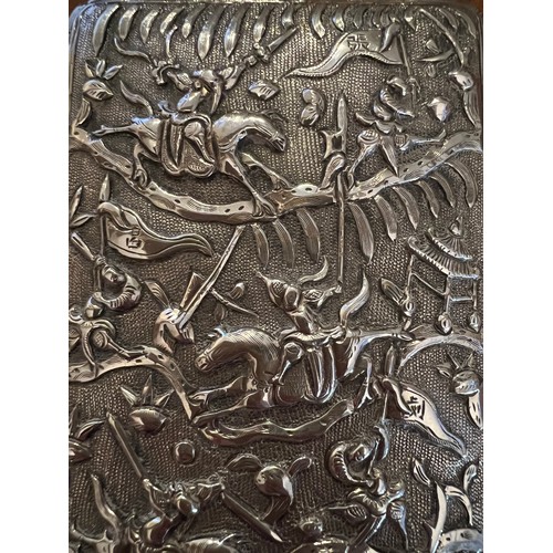 929 - A Chinese silver cigarette case with repoussé decoration, a fight scene to one side, dragon to the r... 