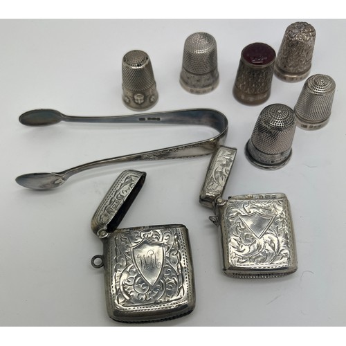 939 - Silver to include 5 hallmarked silver thimbles, 1 with glass top, 1 white metal thimble, 2 vesta cas... 