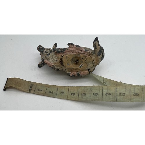 1271 - An early 20thC metal sheep tape measure. 5cm l. Measures centimetres and inches.