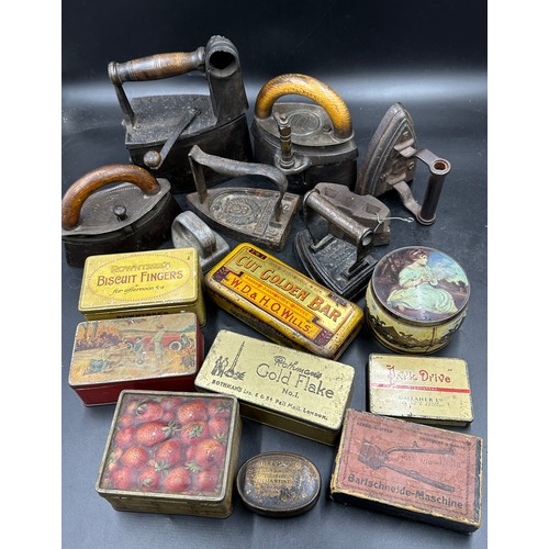 1278 - A collection of sad irons, CH Crane, Otto etc together with various tins to include Rowntree's Biscu... 