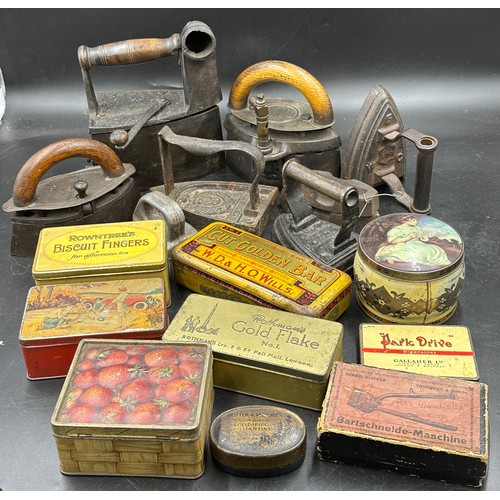 1278 - A collection of sad irons, CH Crane, Otto etc together with various tins to include Rowntree's Biscu... 