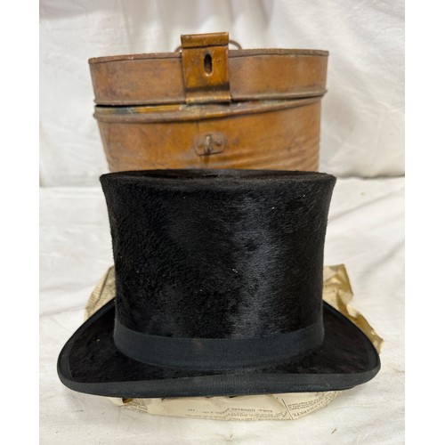 1280 - A silk top hat by J Robinson & Sons, Driffield. Approx. circumference 58cm, in a metal hat box.