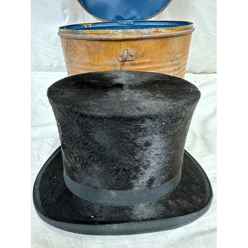 1280 - A silk top hat by J Robinson & Sons, Driffield. Approx. circumference 58cm, in a metal hat box.