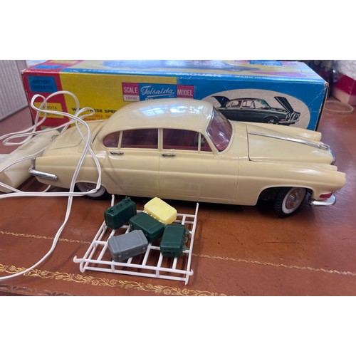 1115 - Telsalda De Luxe Jaguar Mark 10 Saloon, cream plastic body with friction motor, roof rack and five p... 