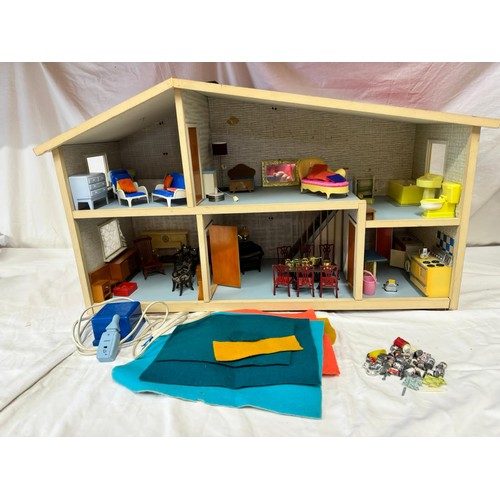 1153 - A Lundby Dolls House to include furniture by Marx, Tri-ang and various others some wooden. Approx 63... 