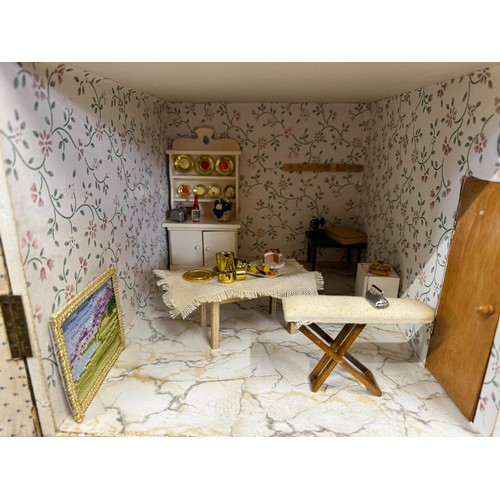 1154 - A large 20thC doll's house opening to reveal decorated rooms over 3 stories. 74cm x 96cm h to includ... 