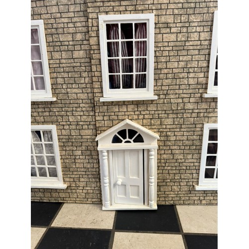 1154 - A large 20thC doll's house opening to reveal decorated rooms over 3 stories. 74cm x 96cm h to includ... 