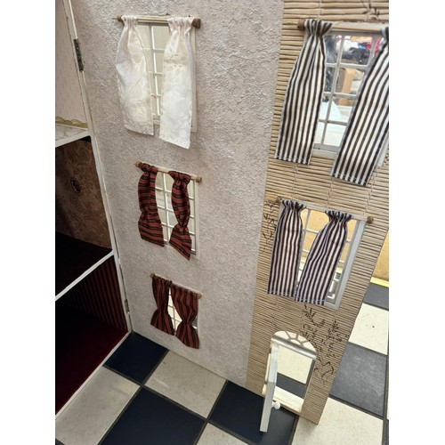 1154 - A large 20thC doll's house opening to reveal decorated rooms over 3 stories. 74cm x 96cm h to includ... 