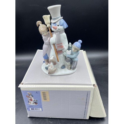 220 - A boxed Lladro porcelain figure group 5713 The Snow Man, 20.5cm h.