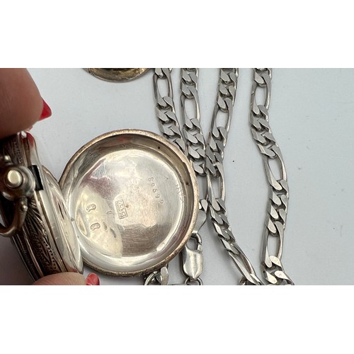 751 - A continental silver pocket watch, marked .935 with winding key, a .925 silver chain, metal framed c... 